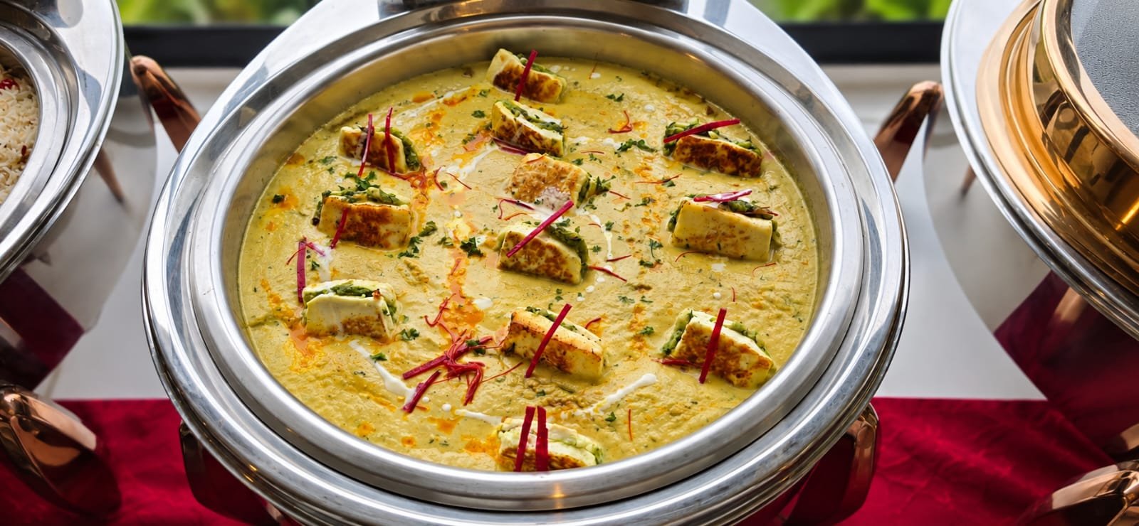 Paneer curry in a creamy gravy, garnished, served at a Grandeur Hospitality event