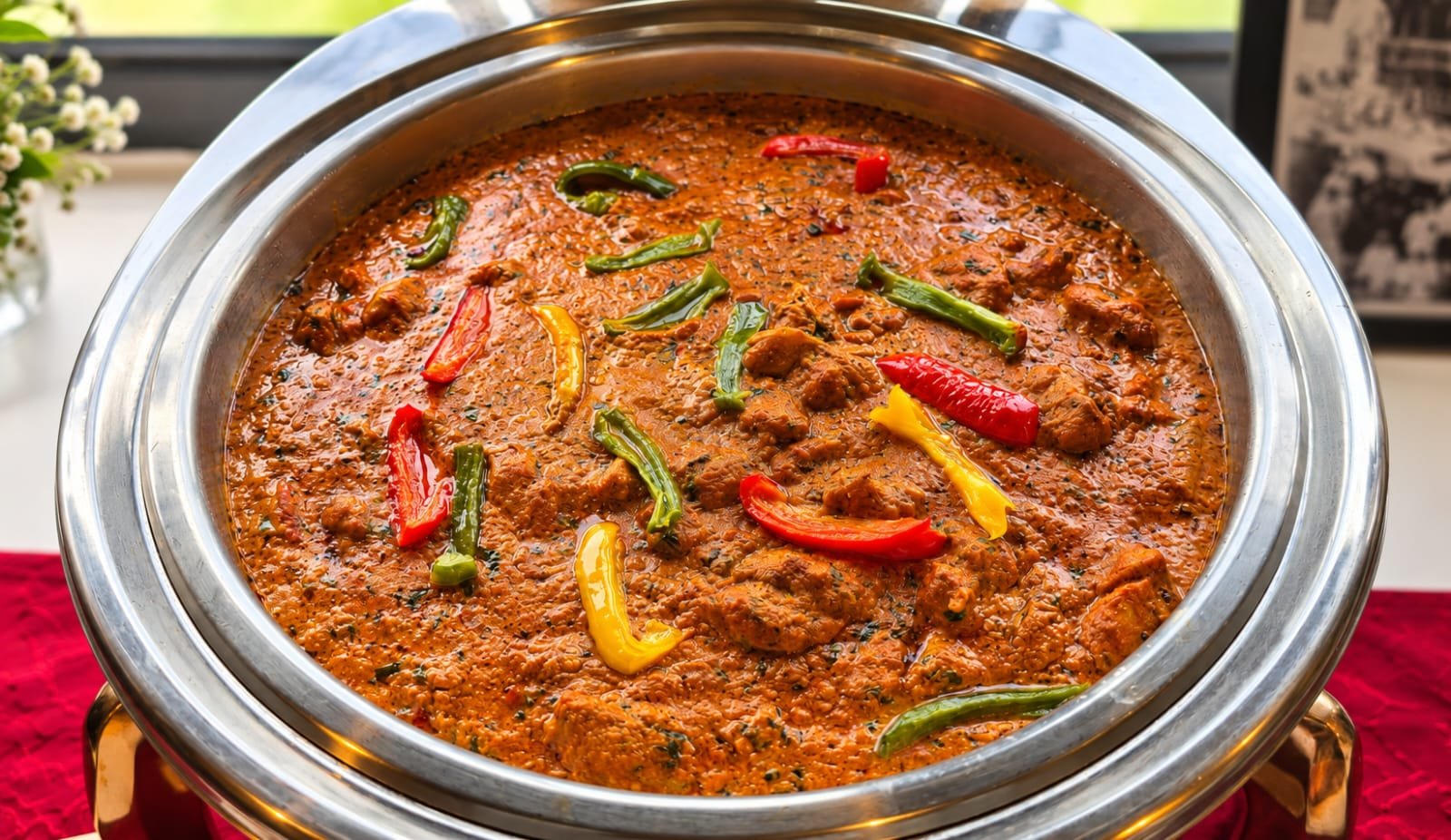 Spiced curry with bell peppers in a chafing dish at a Grandeur Hospitality buffet