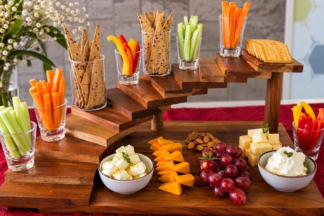 Wooden tiered crudite and snack display by Grandeur Hospitality