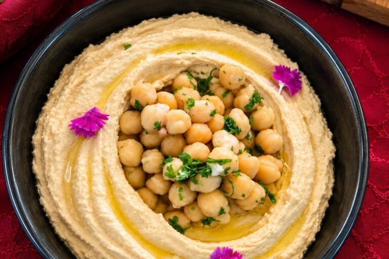 Hummus with chickpeas and herbs served at a Grandeur Hospitality event