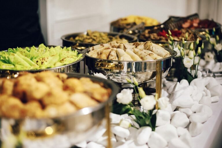 Buffet table with chafing dishes and plated starters