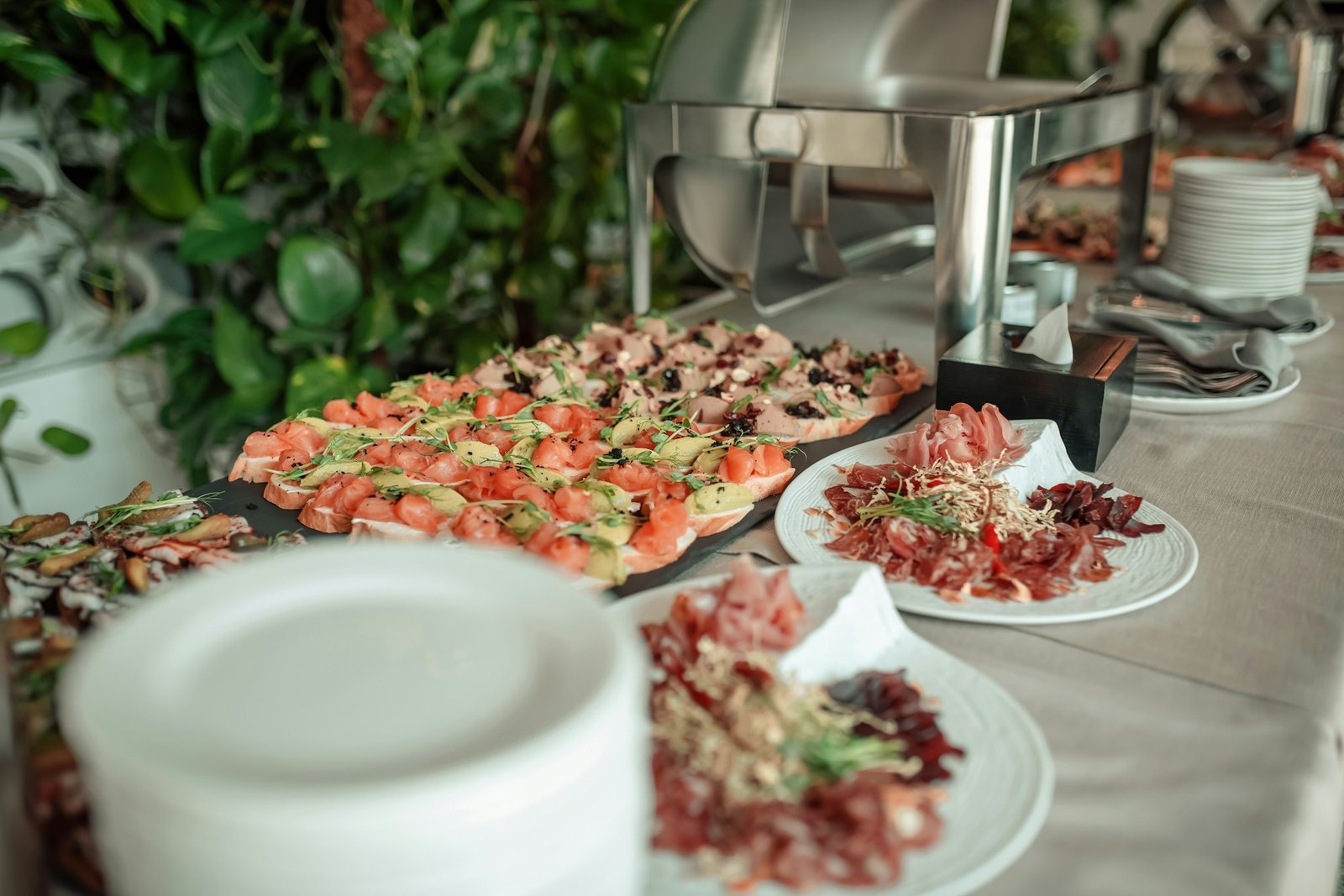 Catering buffet table with chafing dishes and appetizers