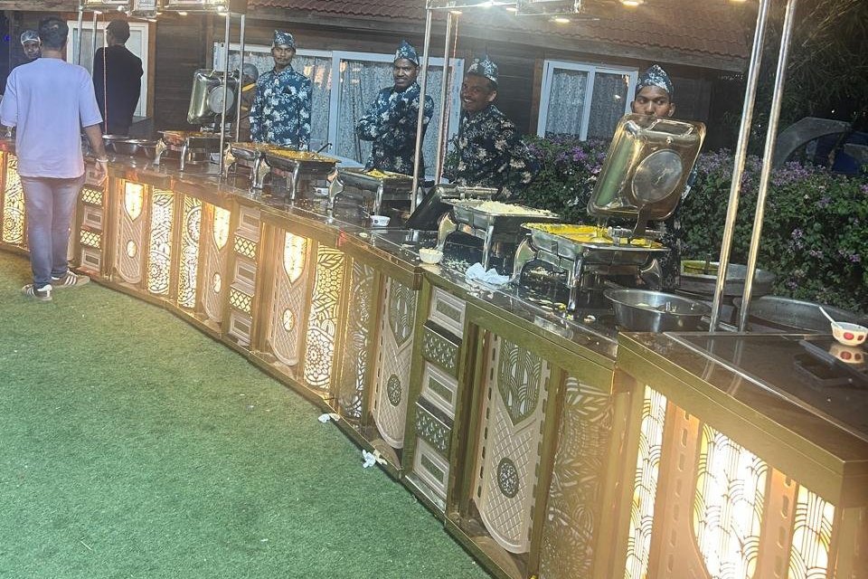 Evening live counters set up on a lawn at a Grandeur Hospitality event
