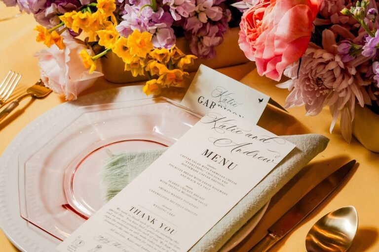 Place setting with a printed menu and flowers on a table