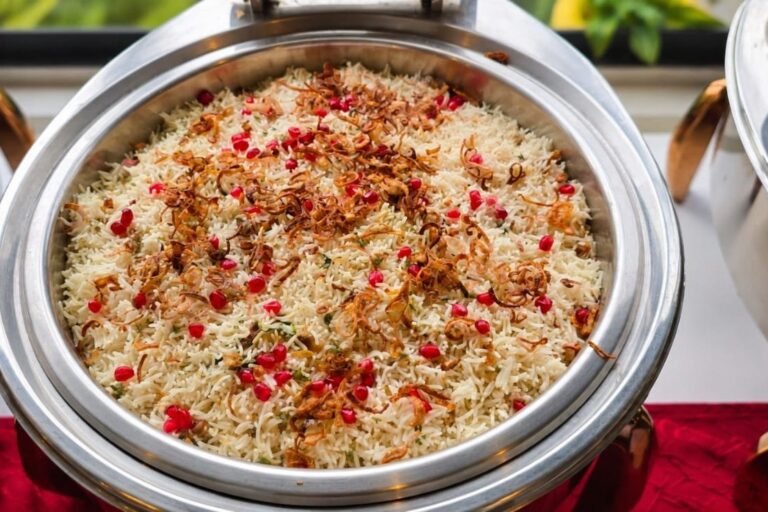 Pomegranate and saffron rice pulao in a chafing dish at a buffet