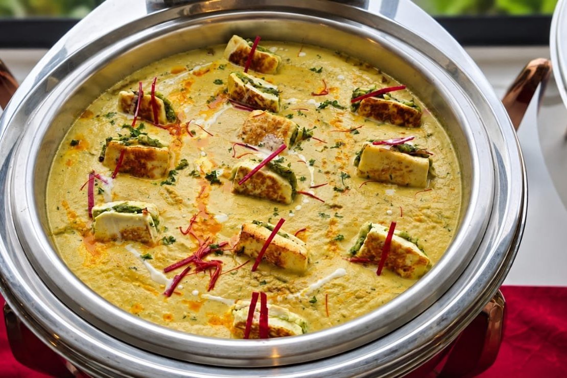 Paneer curry garnished with saffron, served at a Grandeur Hospitality event