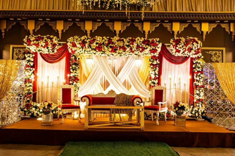 Ornate Indian wedding stage decorated with flowers and drapes