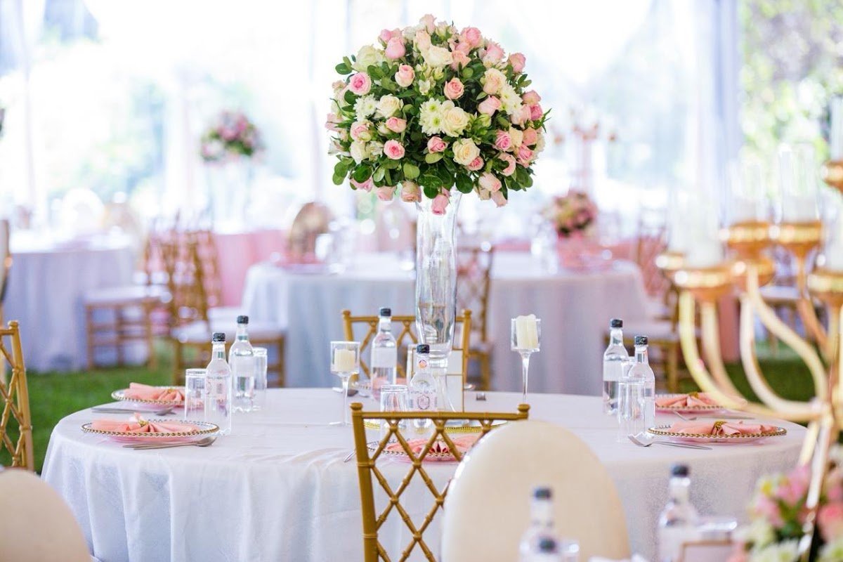 Floral centerpiece and table setting at a Grandeur Hospitality wedding